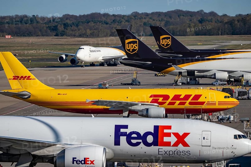 Cologne-Bonn Airport, CGN, UPS Boeing 747 freighter rolls on the apron, at the logistics center, FedEx Boeing 777F and DHL cargo aircraft on the apron, at the logistics center