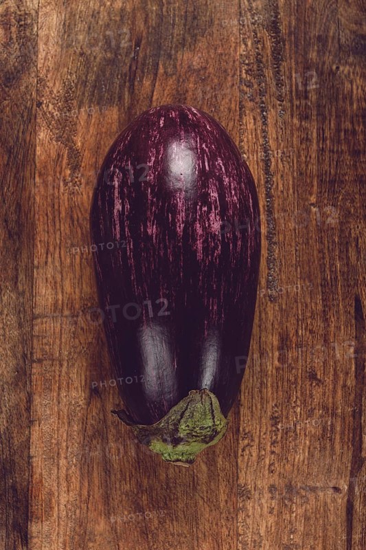 Purple and white eggplant, on a wooden chopping board, top view, raw eggplant, no people