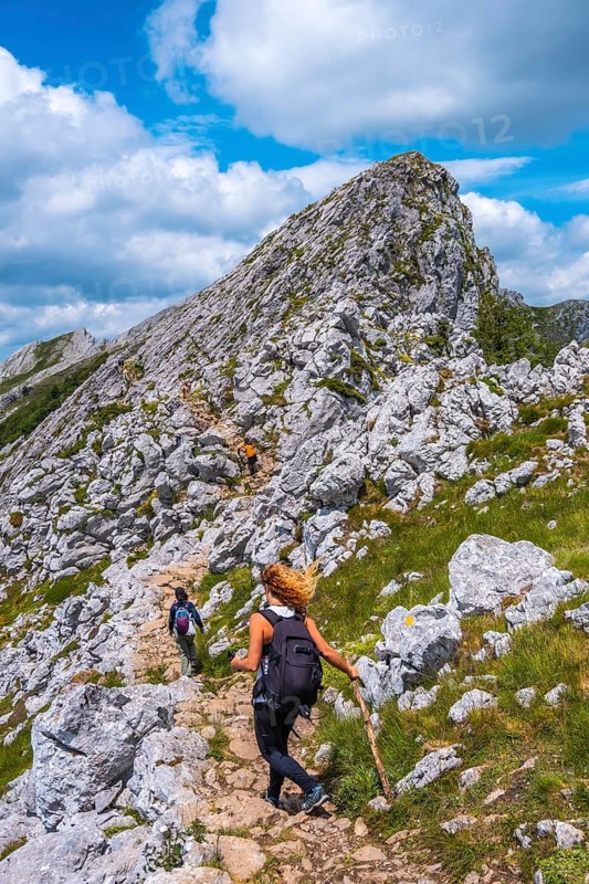 Mount Aizkorri 1523 meters, the highest in Guipúzcoa. Basque Country. Ascent through San Adrián and return through the Oltza fields. Three friends reaching the top of the mountain