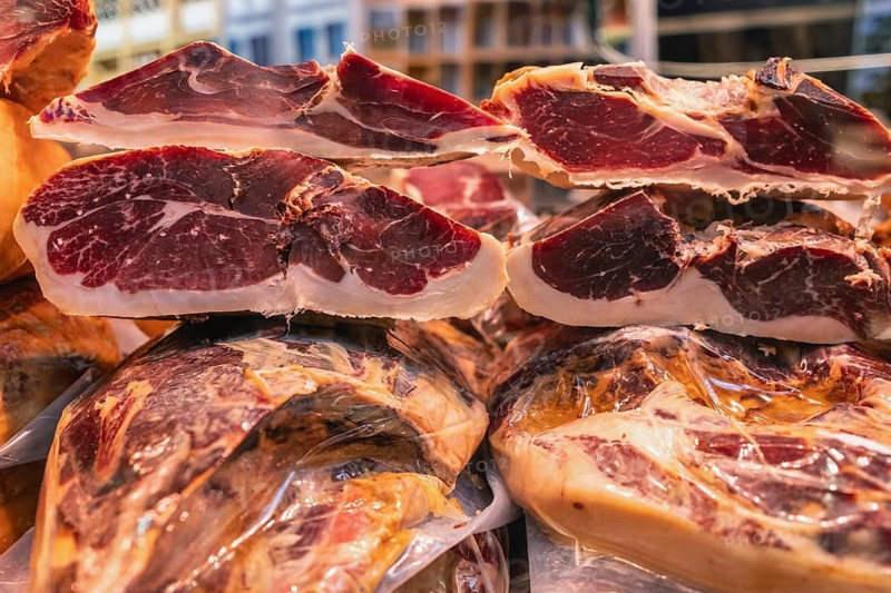 Various pieces of high-quality Spanish jamón, Ibérico, Serrano, ham in the Markthalle Stuttgart, Baden-Württemberg, Germany