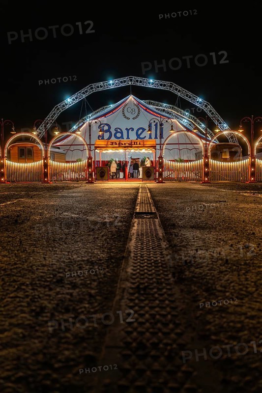 Circus entrance at night with illuminated tent structure and arches, Böblingen, Germany