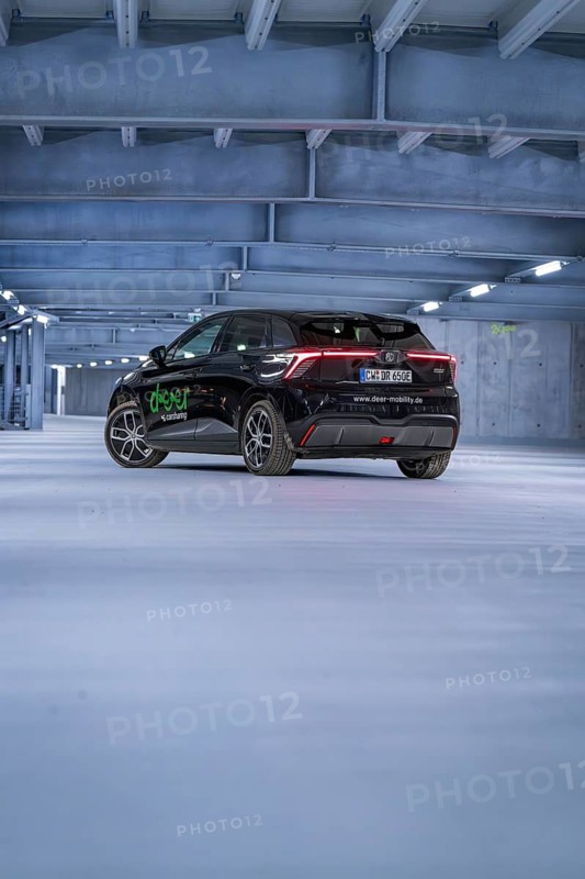 Black car from behind in an empty car park at night, e-car sharing, Deer Mobility, MG4, Calw, Germany