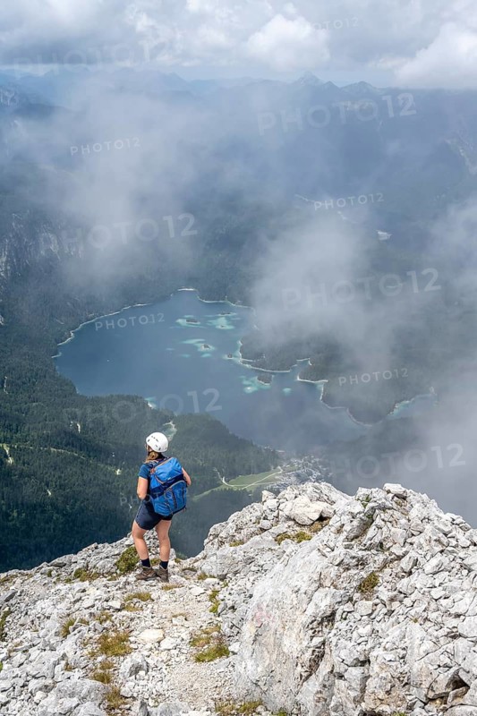 Mountaineer at Waxenstein with fog, Eibsee lake, Wetterstein Mountains, Garmisch-Patenkirchen, Bavaria, Germany