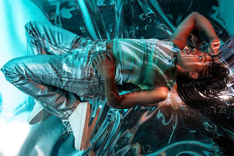 A futuristic vision featuring a young African woman in a vibrant metaverse setting, highlighting digital immersion and modern aesthetics in a colorful, tech-infused environment