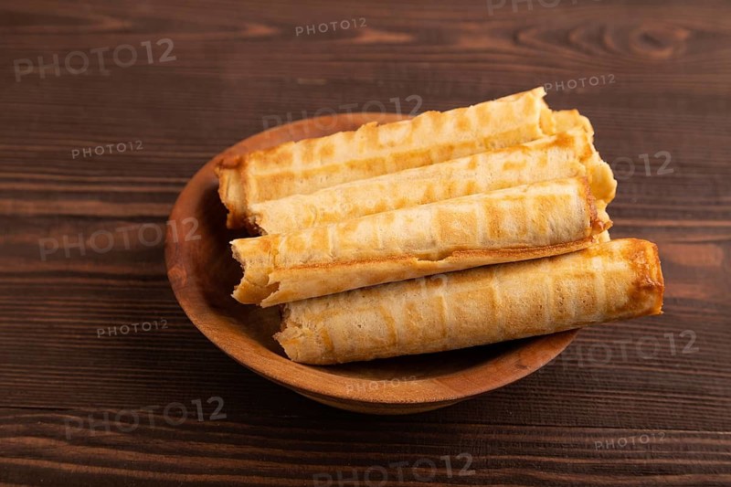Waffles with caramel on brown wooden background, side view, copy space