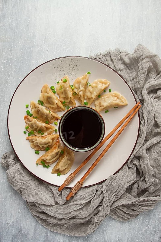 Japanese Gyoza dumplings, fried, with sauce, top view, without people, tinted, selective focus