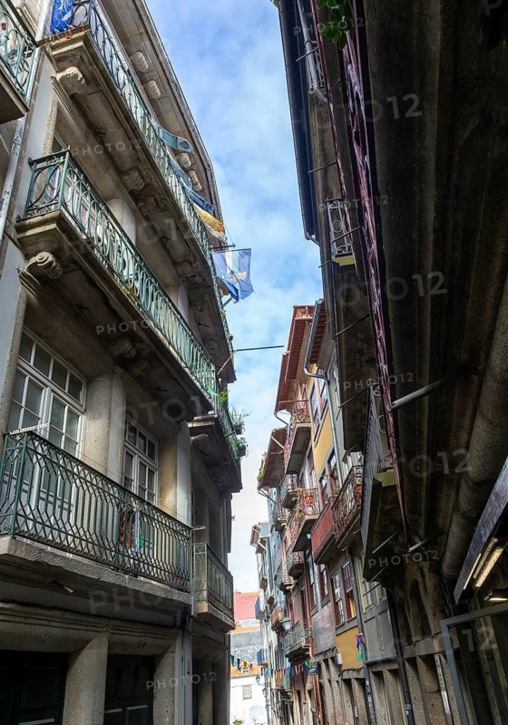 Historic buildings narrow street houses with balconies, Ribeira district, city of Porto, Portugal