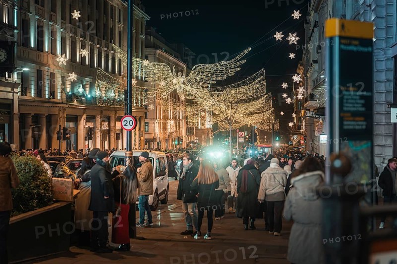 Christmas street view with angels and people walking by, New Year's Eve London, Great Britain