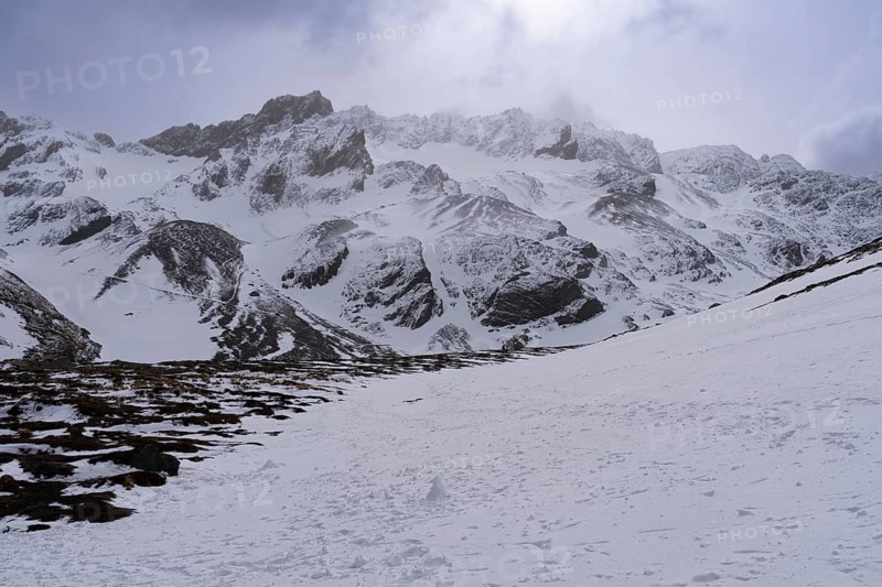 Snowy mountain landscape with rugged rock peaks, clouds and diffuse backlight, Martial Mountains, Ushuaia, Tierra del Fuego, Argentina