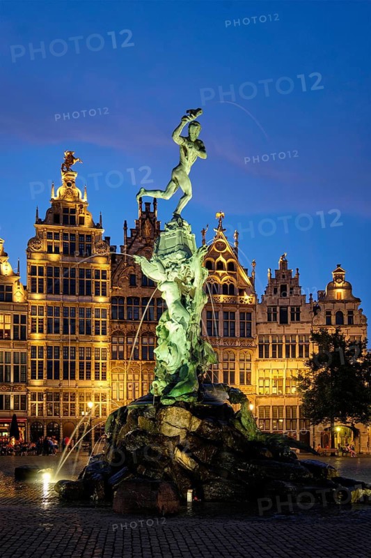 Antwerp famous Brabo statue and fountain on Grote Markt square illuminated at night and old houses. Antwerp, Belgium