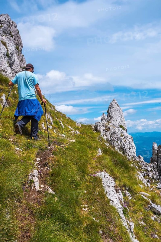 Mount Aizkorri 1523 meters, the highest in Guipuzcoa. Basque Country. A young man climbing with poles to the top. Ascent through San Adrian and return through the Oltza fields