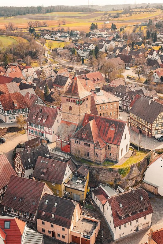 View of a village with a church surrounded by half-timbered houses in a hilly landscape, Ötisheim, Enzkreis, Germany