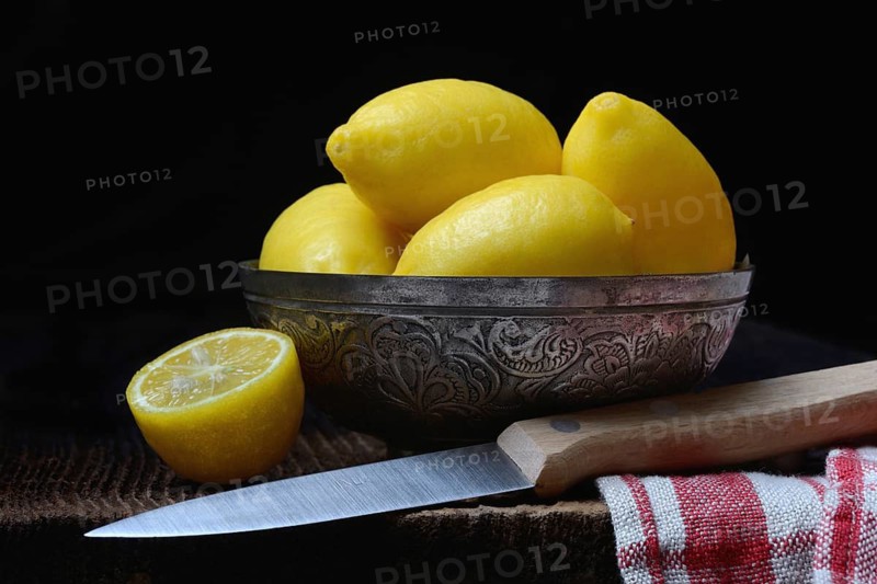 Mini lemons in peel with knife, lemon snack, snack lemon