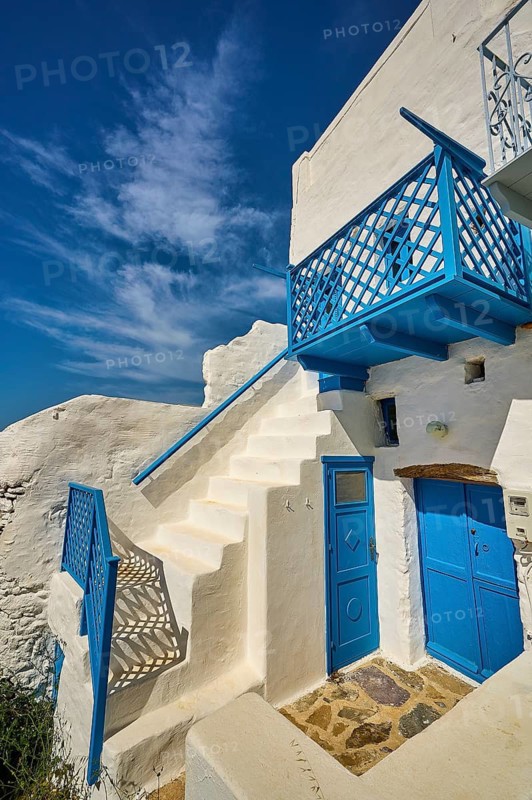 White staircase with blue railing and doors, traditional Greek house under blue sky, Chora, Astypalea, Dodecanese, Greek Islands, Greece