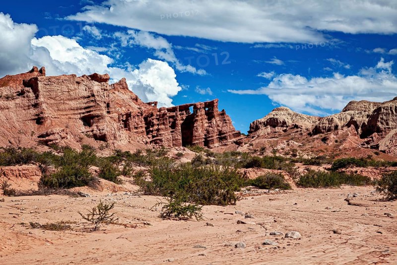 An extensive desert landscape with distinctive rock formations and an intense blue sky, the landscape and colorful rock formations of the Quebrada de Cafayate near Salta in Argentina