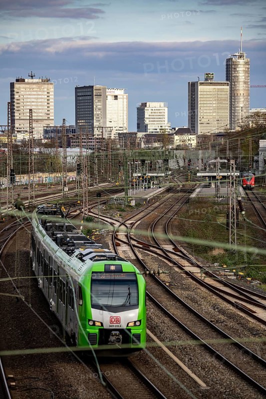 Train on the tracks west of Essen main station, skyline of the city centre, S-Bahn train, North Rhine-Westphalia, Germany