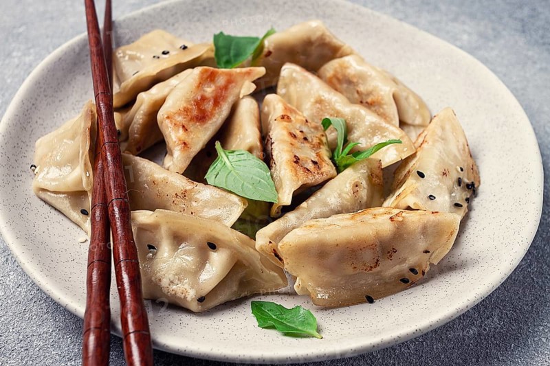 Japanese fried dumplings, gyoza, sesame seeds, top view, no people