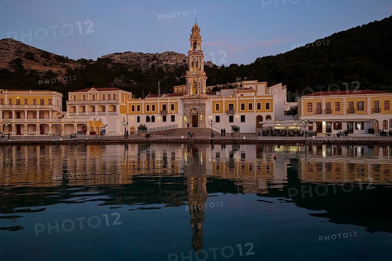 Night view of an illuminated church with reflection in the calm coastal waters, Holy Week, Bay of Panormitis, Panormitis Monastery, Symi, Dodecanese, Greek Islands, Greece