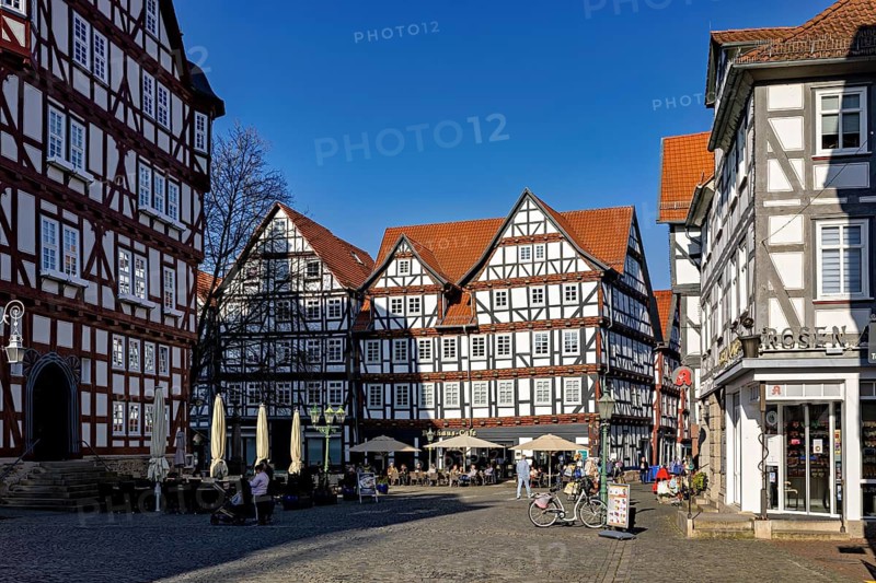 Historic market square with impressive half-timbered houses under a blue sky, The old town centre of Melsungen