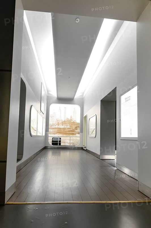 A bright, minimalist interior with high ceilings and large windows that let in natural light, German kinematics, Berlin, Germany