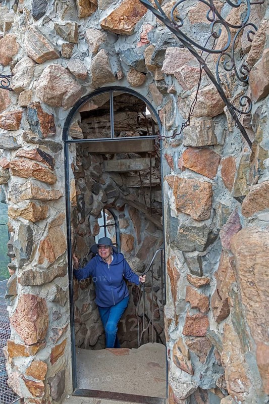 Rye, Colorado, A visitor climbs an interior stairway at Bishop Castle. The Castle is an elaborate stone and metal structure and roadside attraction. It is being built by Jim Bishop in the mountains of San Isabel National Forest