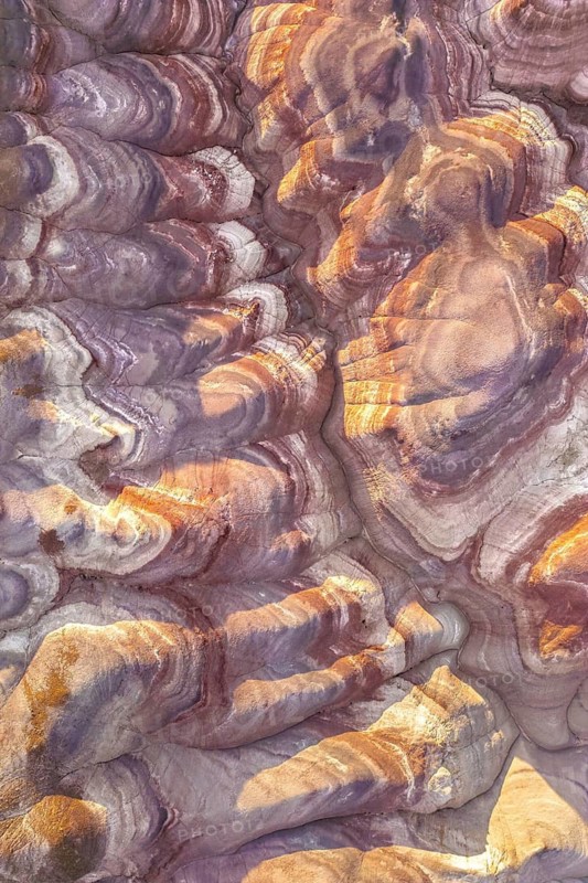 A close-up view of Utah's unique golden bentonites, highlighting their vibrant hues and intricate patterns. This natural artwork displays stunning geological formations