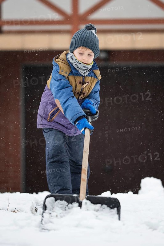 Little boy ploughs the drive