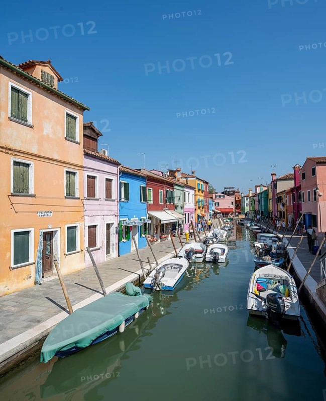Colourful houses on the canal with reflection, Canal with boats and colourful house facades, Burano Island, Venice, Veneto, Italy