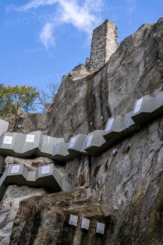 Safety system consisting of rock nails, rock anchors and free-play anchors on the rock of the Drachenfels, part of a former quarry, the elaborate safety measures were installed below the castle ruins, steel rock nails and a concrete corset are intended to maintain the stability of the rocks, North Rhine-Westphalia, Germany