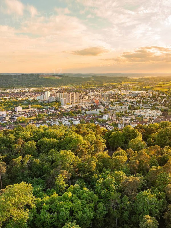 View over the city with skyscrapers and surrounding forests at sunset, Engelberg Tower, Leonberg, Germany