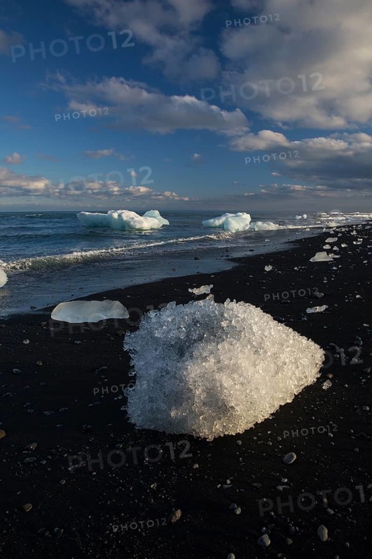 Little icebergs and crushed ice on the black beach at Joekulsarlon glacial lake