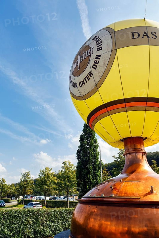 Hot air balloon on a brewing kettle, brewing kettle, advertising with logo, car park, visitor centre of the Warsteiner Brewery, Warstein, Sauerland, North Rhine-Westphalia, Germany
