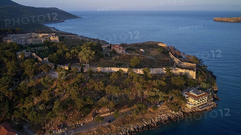 Drone shot, view of a historic fortress on the coast at sunset and calm sea, fortress complex, Neokastro, Pylos, Peloponnese, Greece