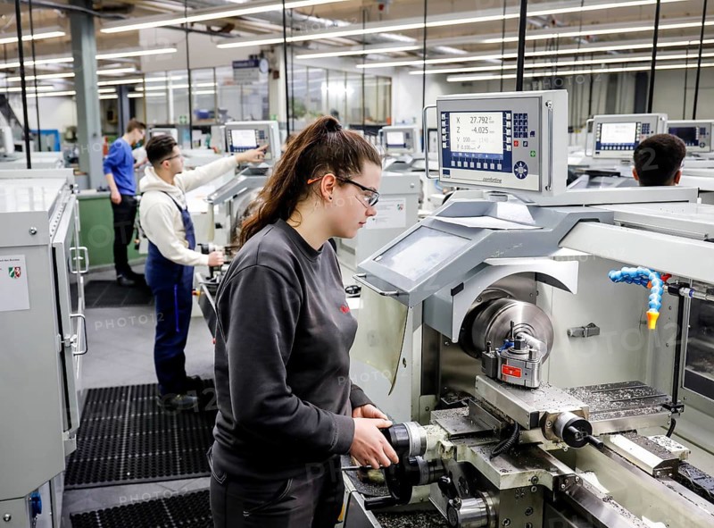 Remscheid, North Rhine-Westphalia, Germany - Trainee woman in metalworking professions working on the lathe, Remscheid Vocational Training Centre for the Metal and Electrical Industry. - FOR EDITORIAL USE ONLY!