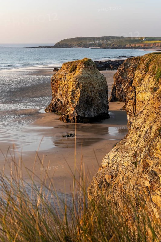 Coastal landscape in Cornwall. Gwithian Beach with sandy beach, dunes and rocks. Evening, golden hour. Gwithian, Hayle, Cornwall, England, Great Britain