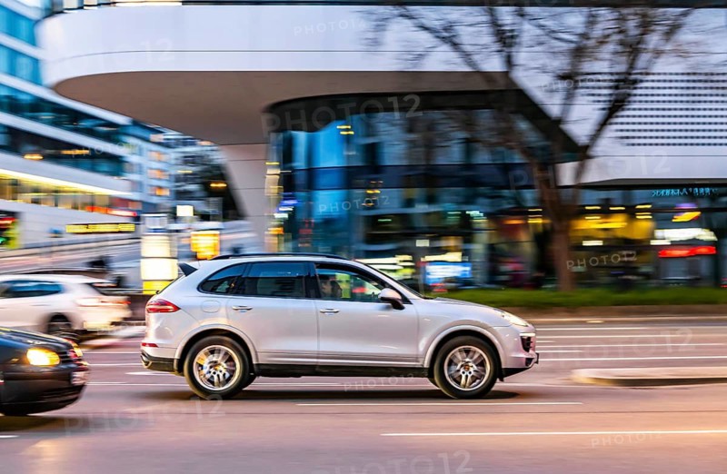 Car at night in front of an urban environment with modern architecture, driver. Stuttgart, Baden-Württemberg, Germany