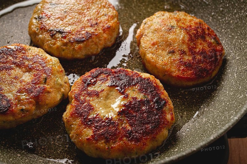 Fried chicken cutlets, with vegetables, in a frying pan, homemade, no people