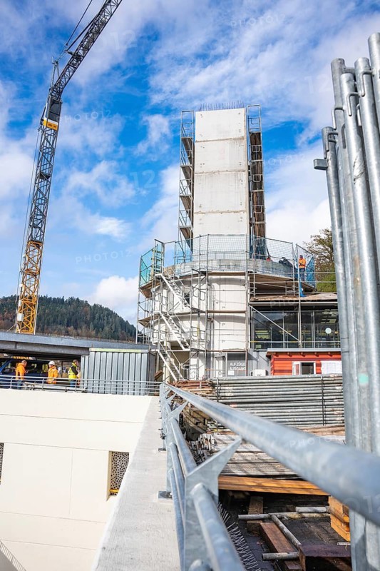Unfinished building with scaffolding and crane at the edge of the construction site, extension of the Calw railway station for the new track of the Hermann Hessebahn, Calw, Black Forest, Germany