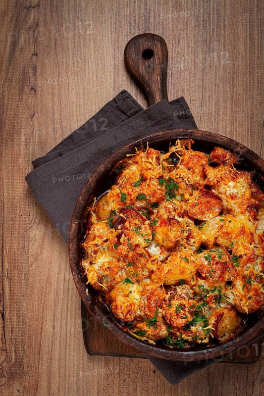 Baked fish with potatoes and cheese, gratin, homemade, no people