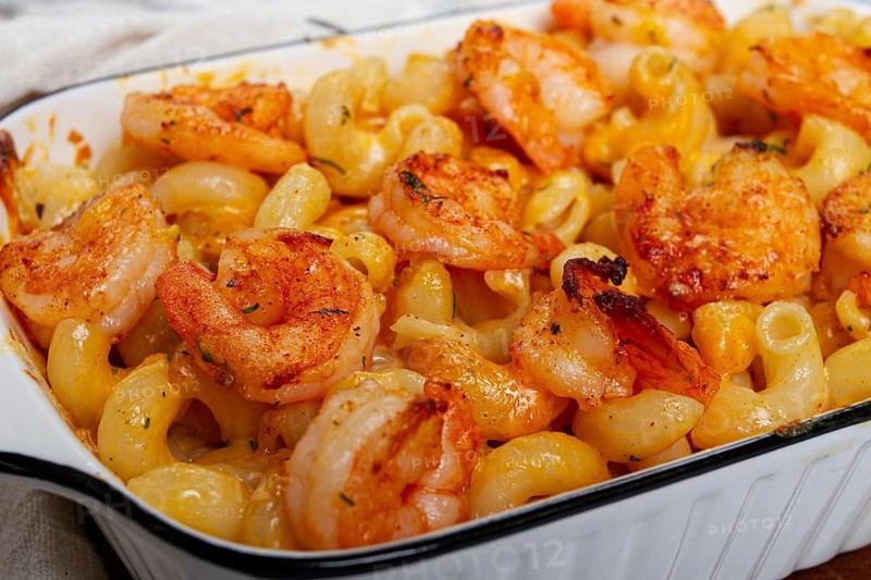 Pasta with shrimp and cheese, with a golden crust, cooked in a baking dish, homemade, no people