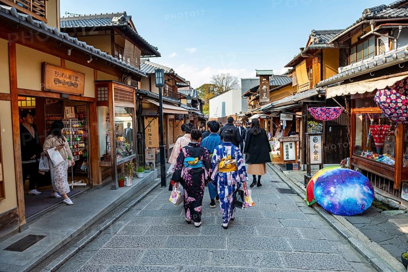 Two Japanese woman wearing colorful kimonos in an alley with traditional Japanese houses, Higashiyama, Kyoto, Japan