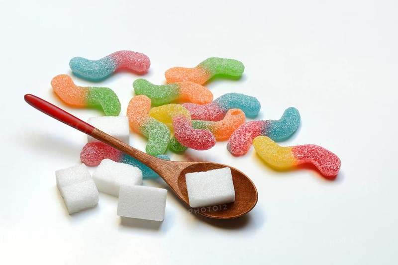 Lots of colorful jelly candies and sugar cubes, sugar consumption
