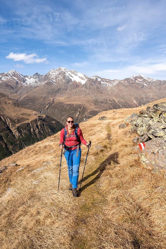 Hiker on hiking trail, snow-covered mountains, Ötztal, Tyrol, Austria