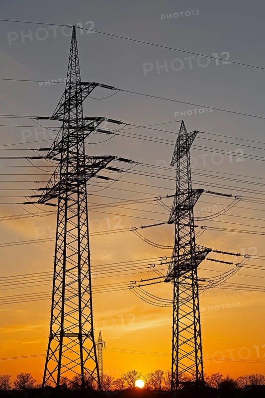 Sunset behind high-voltage pylons, Häcklingen, Lüneburg, Lower Saxony, Germany