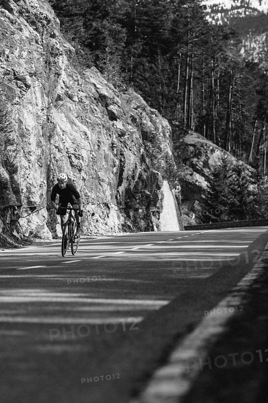 Road bike rider in spring in the Allgäu against the picturesque backdrop of the Alps, Bavaria, Germany