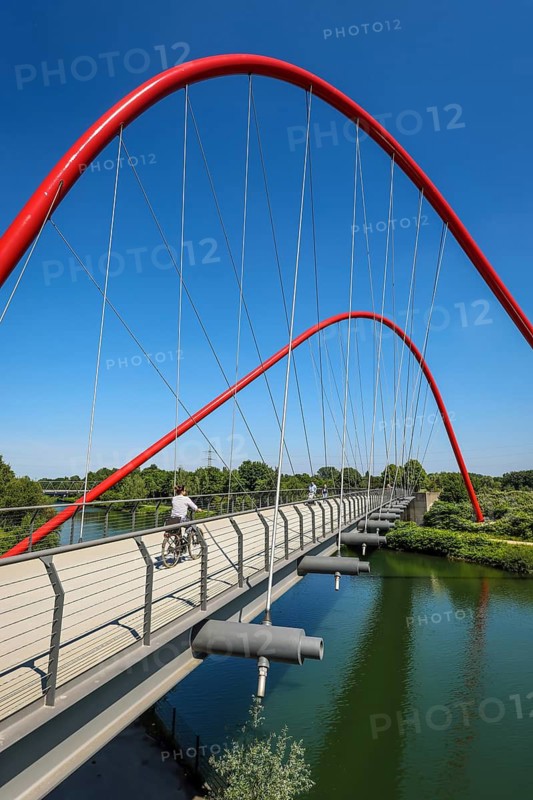 30.07.2022, Gelsenkirchen, North Rhine-Westphalia, Germany, Nordsternpark, here with the double arch bridge on the Rhine-Herne Canal. Parks and gardens in the Ruhr area. Nordsternpark is a landscape park on the site of the former Nordstern colliery in Gelsenkirchen. Following the closure of Nordstern colliery in 1993, the site was completely renovated and transformed into a landscape park. The Federal Garden Show was held in the park in 1997. The site will be further redesigned as part of the IGA 2027. 00X220730D035CARO (MODEL RELEASE: NO, PROPERTY RELEASE: NO (c) caro images / Rupert Oberhaeuser, http://www.caro-images.com, info@caro-images.com, If the photo is used for purposes other than journalism, please contact the agency, Any use of the photo is subject to a fee !)