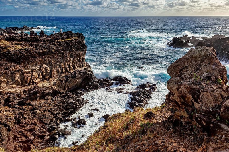 Dramatic coastal cliff with foaming waves against rocks, Easter Island landscape in the Pacific Ocean