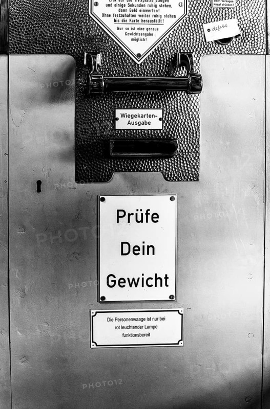 Black and white photograph, old bathroom scales with coin slot, Berlin, Germany