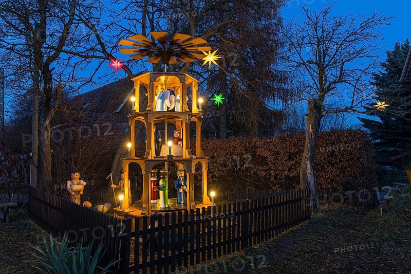 Christmas pyramid with wooden figures in the village of Unkersdorf in the evening, Dresden, Saxony, Germany