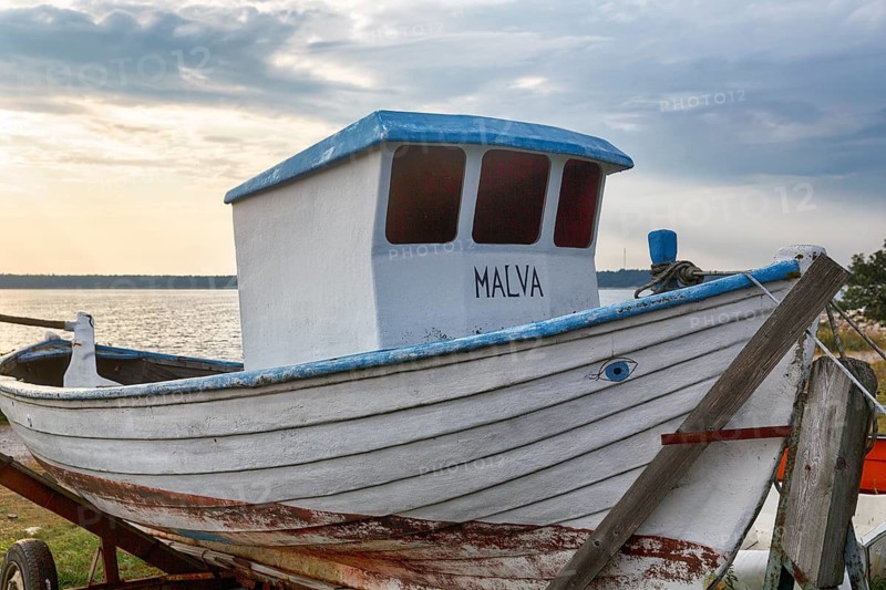 Old white fishing boat with cab, painted evil eye, traditional symbol, protection against misfortune, Sysne Fiskeläge, historic fishing village, Katthammarsvik, Östergarnland, east coast, island of Gotland, Baltic Sea, Sweden